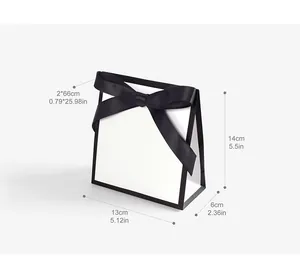Minimalist white gift paper bag with black ribbon bow and precise dimensions