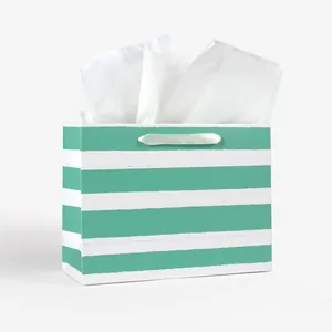 Elegant green and white striped gift bag with white satin handles and tissue paper