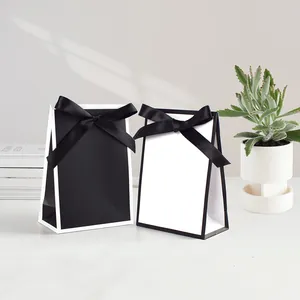 Minimalist black and white gift bags with elegant satin bows for jewelry packaging