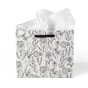 Square white paper gift bag with black floral line art and woven rope handles