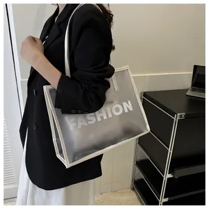 Detail of translucent frosted tote bag with white trim and FASHION logo text