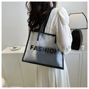 Detail showing frosted semi-transparent tote bag with black FASHION text and inner pouch