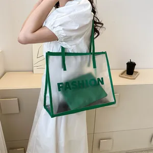 Minimalist clear PVC tote bag with green interior pouch and Fashion text on shoulder