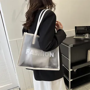 Minimalist white semi-transparent tote bag with FASHION logo and inner pouch shown on model