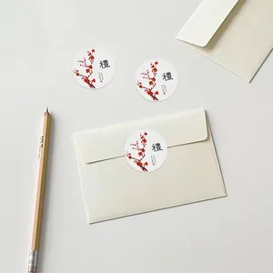 Macro view of plum blossom gift seal stickers on envelopes with elegant calligraphy