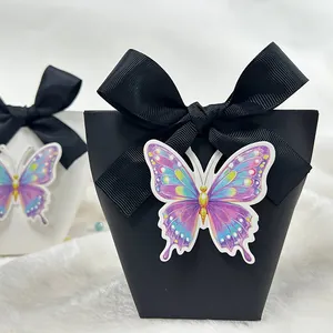 3D butterfly gift box with elegant black ribbon bow on soft white faux fur background