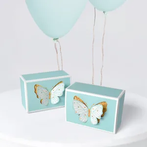 Light blue gift boxes with 3D white and gold butterflies for wedding candy packaging