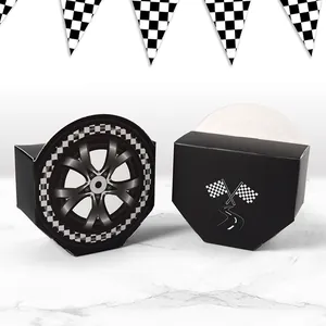 Racing party favor boxes with tire design and checkered flags on marble surface