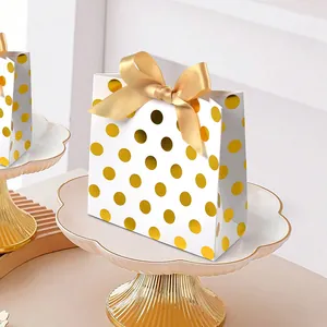 Elegant white paper gift bag with gold polka dots and champagne satin ribbon bow