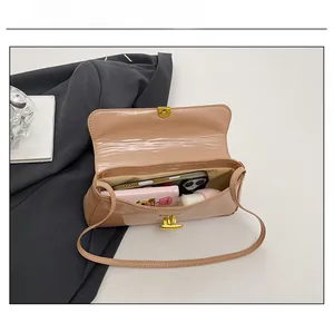 Interior view of nude patent leather bag showing capacity for phone and makeup