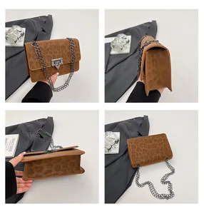 Detail view of leopard print suede crossbody bag with metal chain strap and buckle