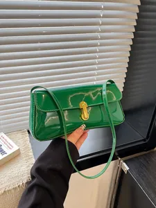 Chic green patent leather rectangular shoulder bag with a gold capsule-shaped metal buckle