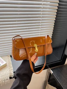 Brown patent leather rectangular shoulder bag with golden metallic buckle