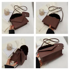 Detail view of brown quilted PU leather handbag with faux fur handle and mini pouch