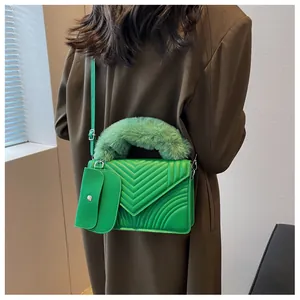 Detail of bright green quilted shoulder bag with faux fur handle and matching coin purse