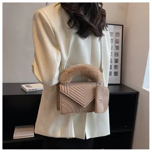 Beige quilted shoulder bag with plush fur handle and mini pouch shown on model