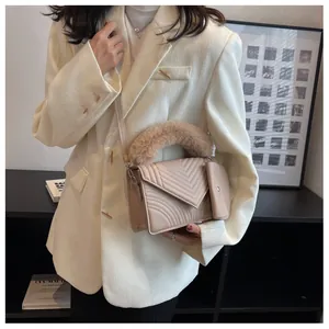Detail of beige quilted shoulder bag with plush handle and small card pouch accessory