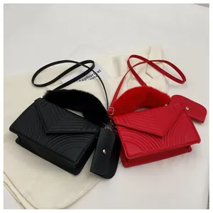 Detail view of V-shaped quilted leather bags in black and red with plush handles