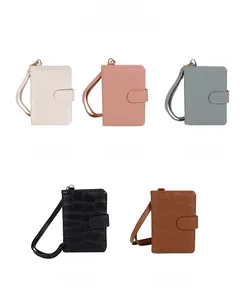 Close-up of portable passport holders in five colors with crocodile texture and wrist straps