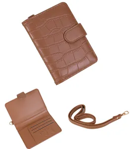 Brown crocodile pattern passport holder with multiple card slots and detachable strap