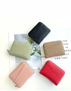Flat lay showing multi-color leather card holders with lychee texture and metal zippers