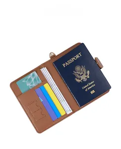 Macro view of brown leather passport holder interior with card slots and a metal D-ring