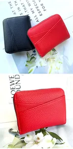 Detail of red and black litchi grain coin purses with metal zipper and V-shaped slots