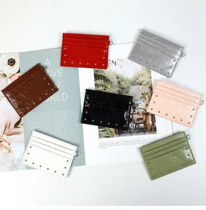 Detail of rivet-studded card holders in seven colors with textured crackle finish