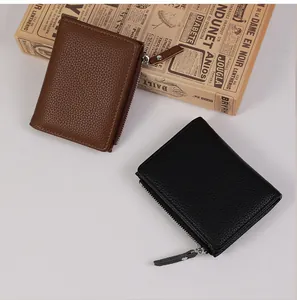 Macro shot of minimalist leather coin purses in black and brown with metal zippers