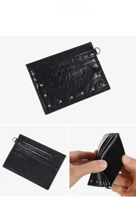 Detail showing black rivet card holder with cracked texture leather and accordion slots