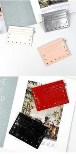 Detail of multi-slot leather card holders with studs and metal D-ring attachment