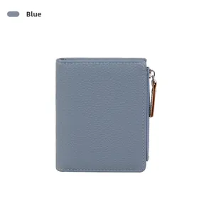 Detail view of blue lychee grain leather wallet with metal zipper and brown puller