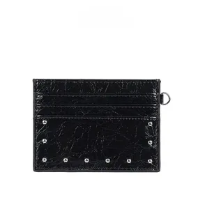 Detail of black cracked leather card holder with silver studs and multi-card slots