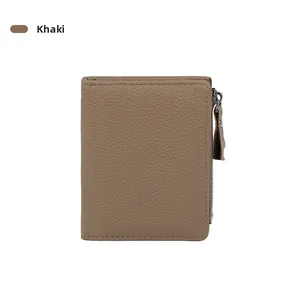 Detail of khaki slim leather wallet with silver metal zipper and textured pebble grain leather