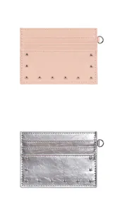 Detail of pink and silver card holders with rivet accents and D-ring metal attachments