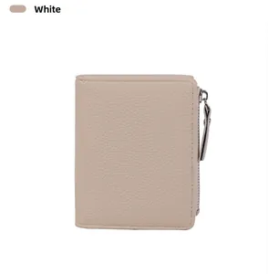 Detail view of cream leather wallet featuring lychee texture and silver zipper