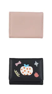 Detail of pink and black lychee texture wallets with cute bow and apple embroidery