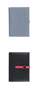 Detail of lychee pattern leather passport covers with fine stitching and metal buckle