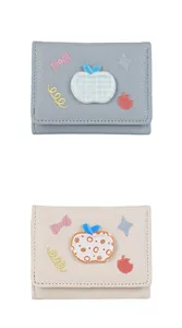 Close-up of litchi texture PU leather wallets with cute 3D apple and bow embroidery