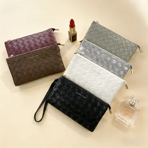 Macro view of woven leather clutch textures in six colors with gold metal zippers