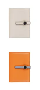 Detail view of lychee pattern leather passport holders with metal snap closure and buckles