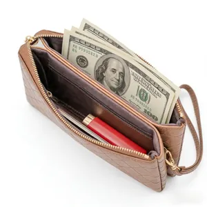 Brown quilted crossbody clutch bag with gold zipper and spacious internal compartments