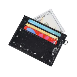 Black crocodile pattern card holder with silver studs and metal ring on white background