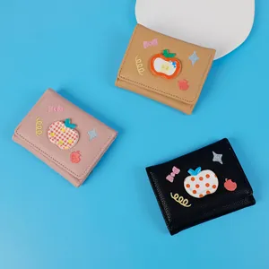 Three-fold leather wallets with apple ornaments and embroidery on blue background