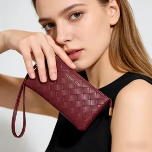 Deep red woven clutch bag with gold zipper and wristlet strap for stylish women