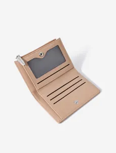 Detail view of small beige bifold wallet showing card slots and transparent photo window