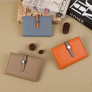 Minimalist pebbled leather short wallets in blue, orange, and brown with metal snap closure