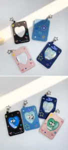 Macro detail of denim card holders with heart-shaped window and star keychain