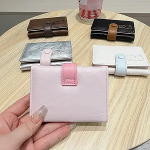Close-up of cute cat motif and textured faux leather finish on colorful small wallets