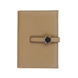 Minimalist khaki leather passport wallet with litchi grain and round snap closure